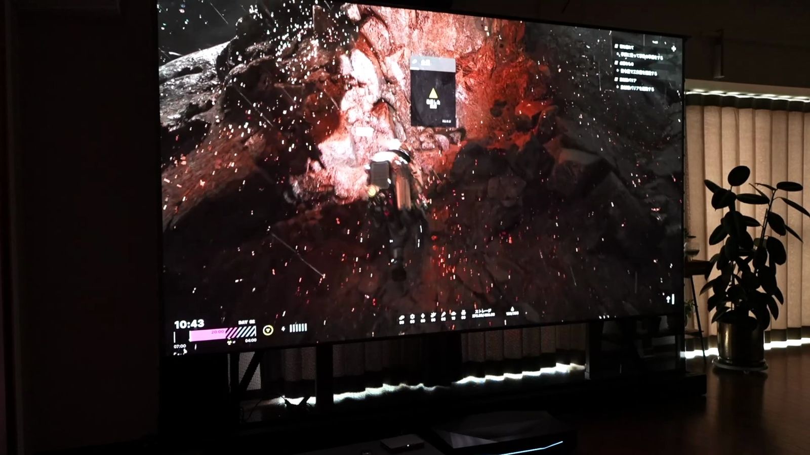 暗いシーンで火の粉が舞うゲームの画面。背景の黒が沈んでいる
