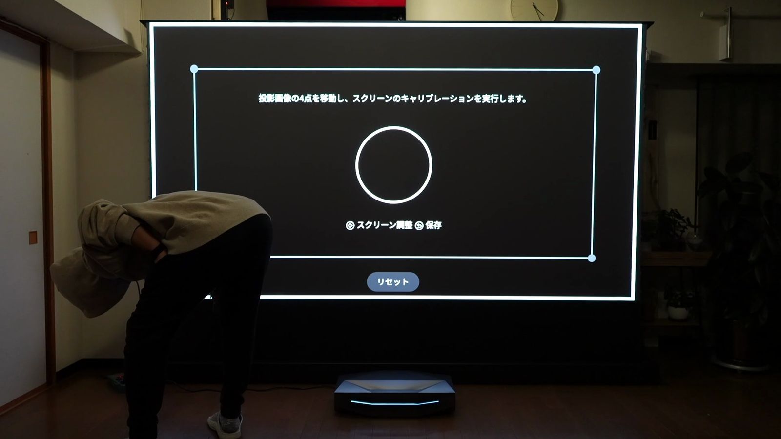 スクリーンに表示したキャリブレーションの枠を見ながら、本体の位置を調整しているところ