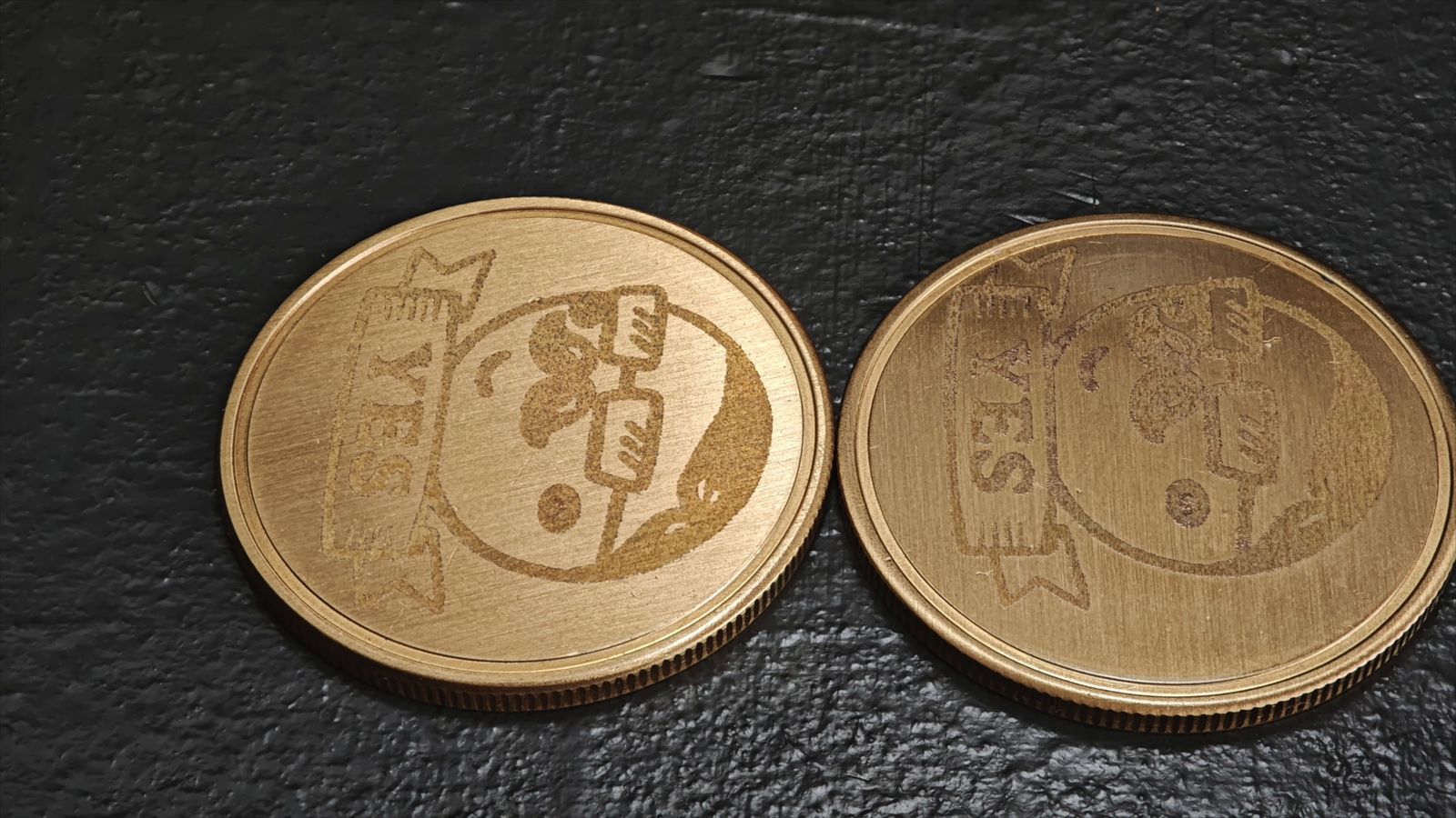 周波数を変えて彫刻した真鍮のコイン2枚