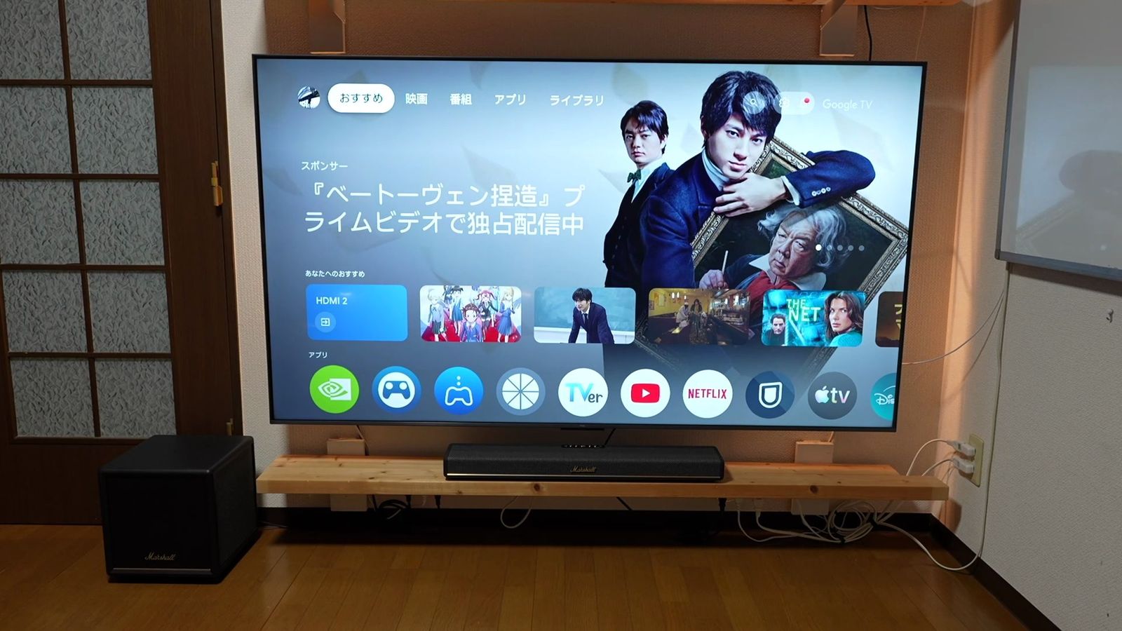 テレビの前に置いたサウンドバーと、左に置いたサブウーファー