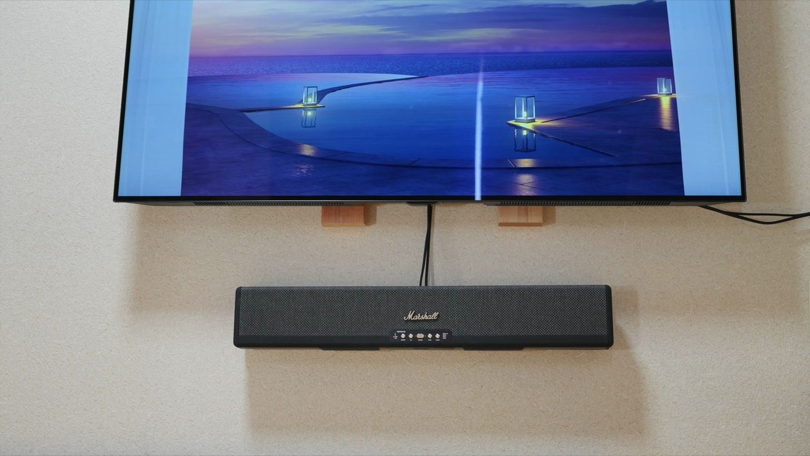 壁掛けしたテレビと、その下のサウンドバー