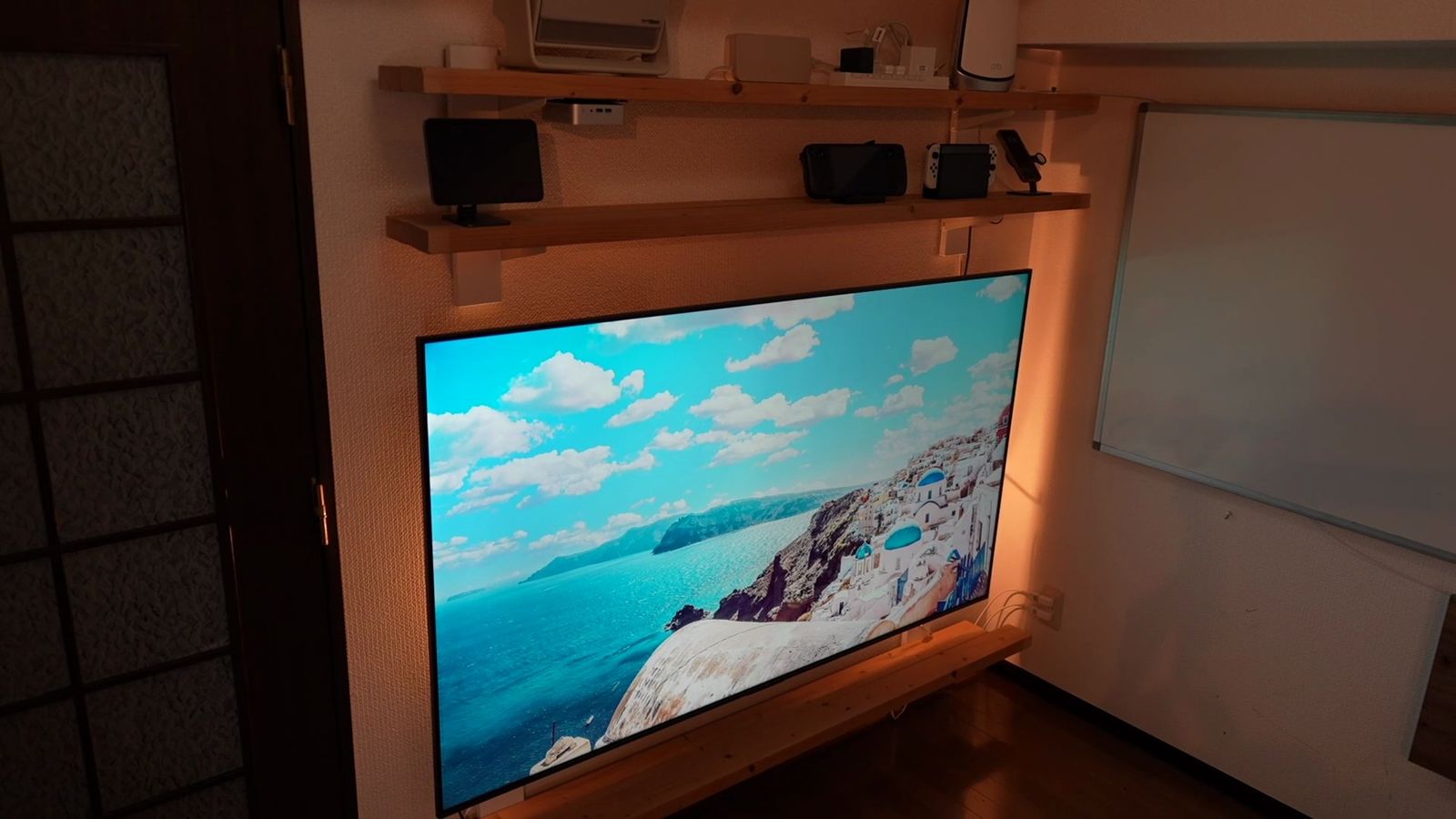 部屋の斜めの位置から見た、壁に固定したC6Kの画面(海辺の町)